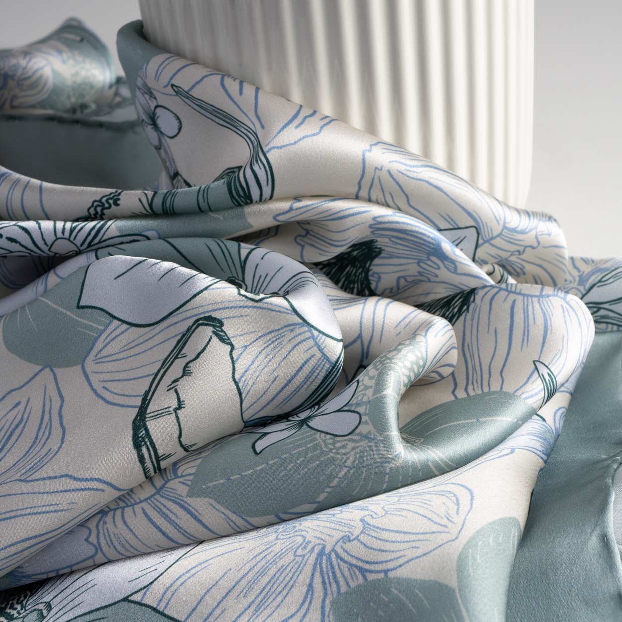 Detail of square silk scarf in light blue tones for women
